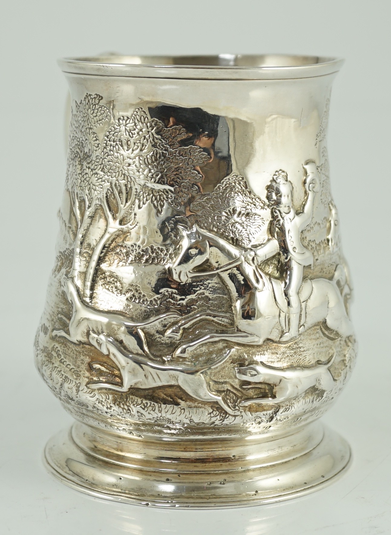 A George II silver baluster mug, later embossed with continuous hunting scene, Richard Gosling